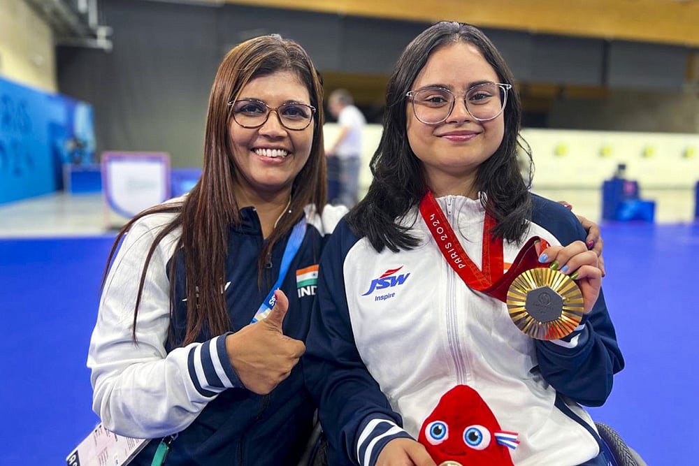 | Photo: PTI : Paris Paralympics 2024: Avani Lekhara with her coach Suma Shirur poses for photos after winning the gold medal in Women's 10m air rifle (SH1) shooting